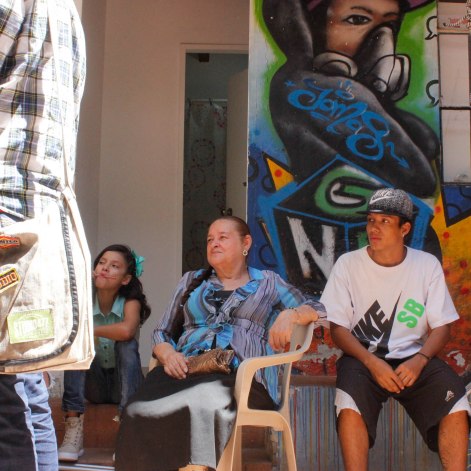 Margoth Yepes, known as "La Abuela Rapera," watches the rappers freestyling.